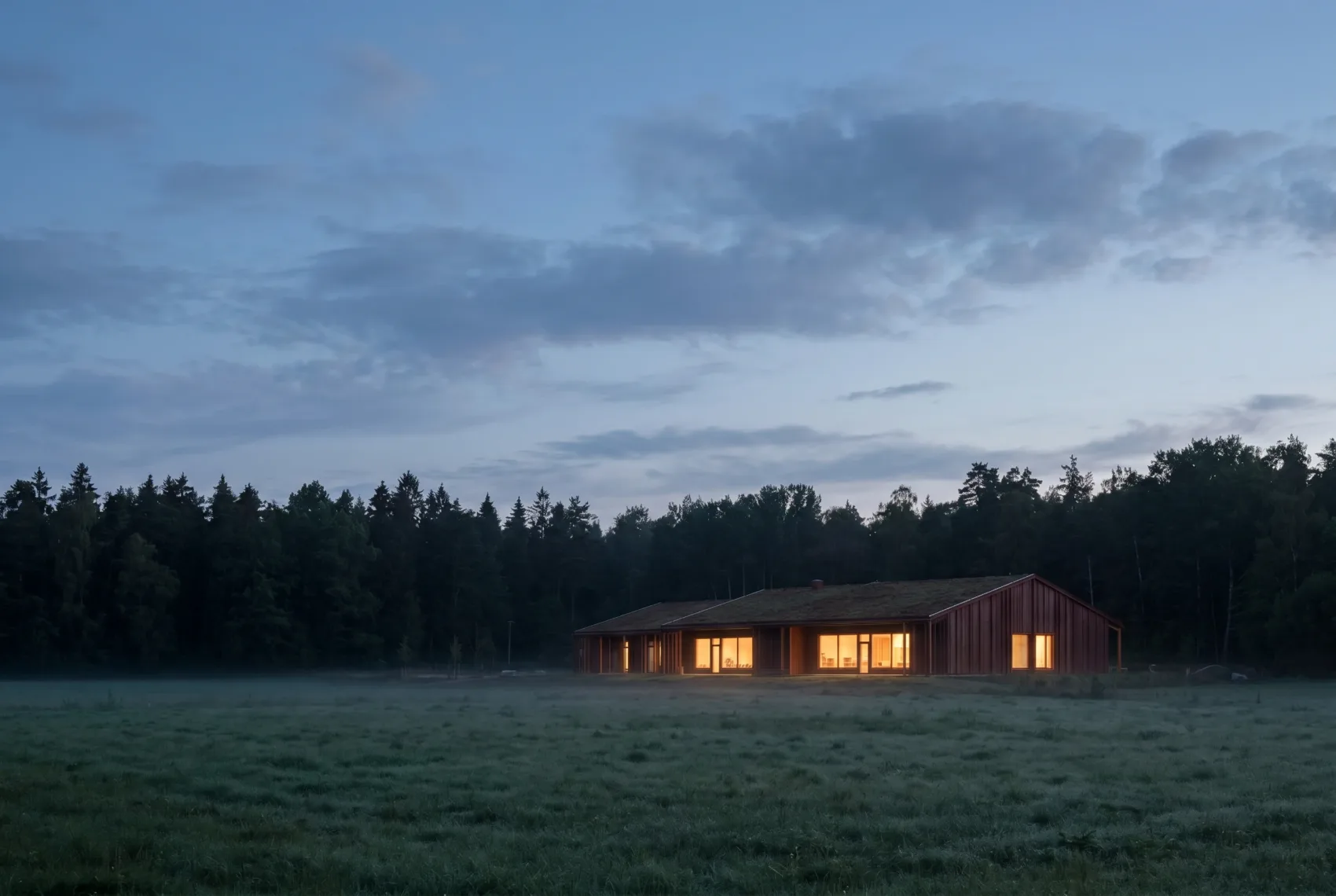Architectural visualisation — the kindergarten small in a misty meadow at dusk, windows glowing warm against the dark forest